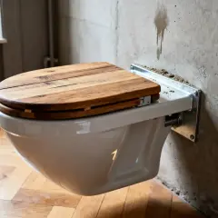 WC suspendu avec abattant en bois, une solution moderne pour optimiser l'espace. La hauteur du WC suspendu est idéale pour un nettoyage facile.