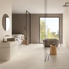 Élégante salle de bain beige et noir avec baignoire, douche, lavabo et lit. Un espace moderne et épuré.