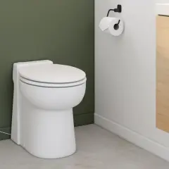 Toilettes modernes avec brosse et prise électrique. Le wc broyeur, discret, est prêt à fonctionner.