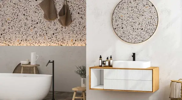 Élégante salle de bain terrazzo avec baignoire, lavabo moderne et miroir rond.
