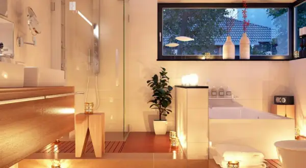 Salle de bain moderne et chaleureuse, baignée de lumière douce. Quel luminaire pour salle de bain choisir pour une ambiance zen ? Bougies et spots discrets créent une atmosphère relaxante.