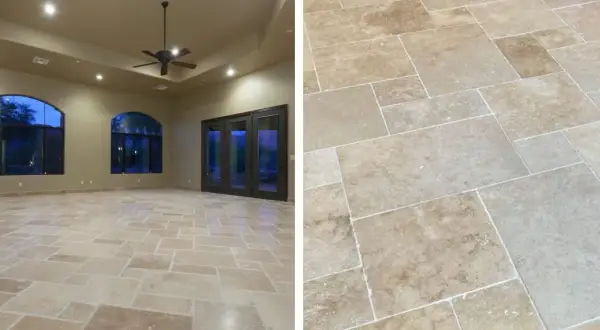 Un salon spacieux avec un sol en mélange travertin et parquet, des fenêtres cintrées et une porte vitrée double.