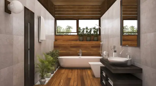 Salle de bain moderne avec baignoire, lavabo et toilettes. Le sol en parquet contraste avec le carrelage mural.