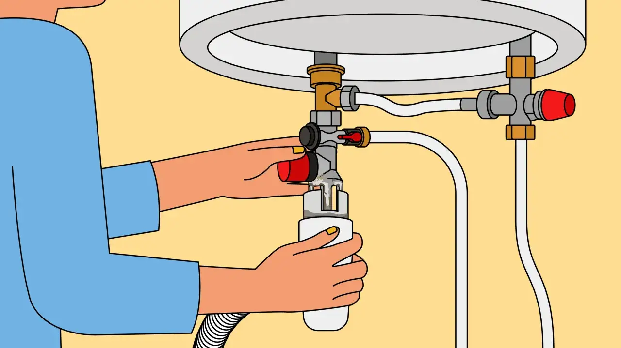 Une personne tourne une vanne rouge pour comment vider un ballon d'eau chaude, un r&eacute;cipient blanc est plac&eacute; en dessous pour recueillir l'eau.