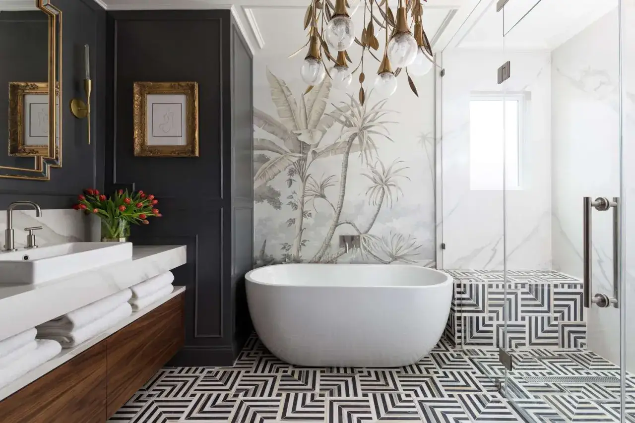 Salle de bain luxueuse avec papier peint tropical, baignoire îlot et carrelage géométrique. Inspiration peinture céramique pour le sol.